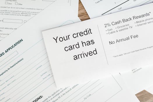 Close-up of a letter announcing the arrival of a credit card amidst financial documents.